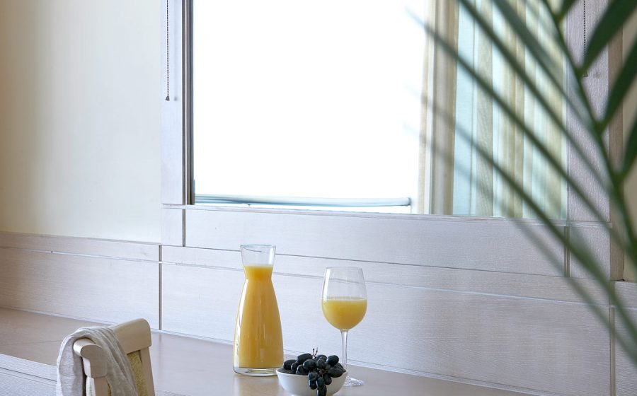 Juice and fruits on the table of a standard room