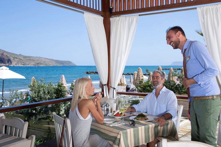 Laughing couple placing an order at restaurant