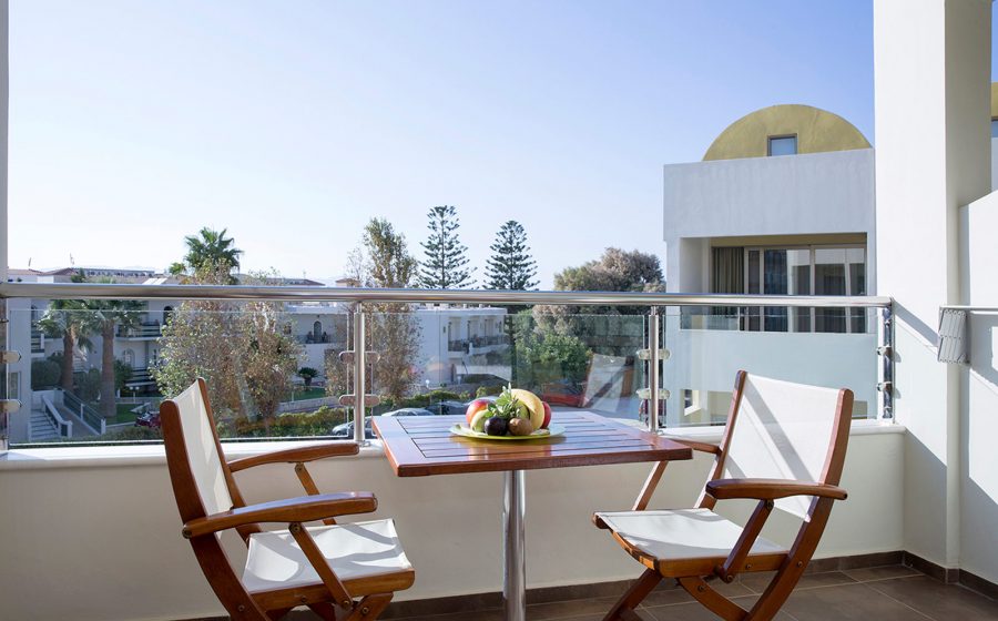 Stabdard room balcony with table and a couple of chairs