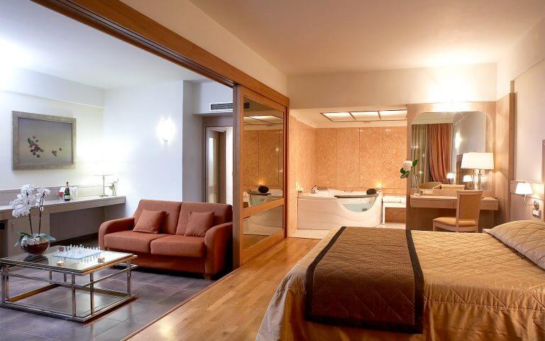 Couch, bed and bathroom of superior suite 