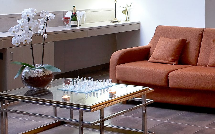 Desk, couch and table with chessboard of a superior suite