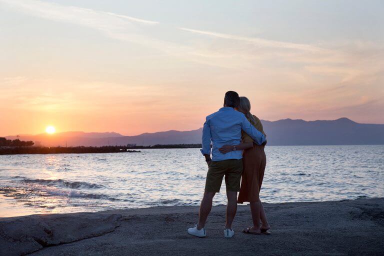 Couple watching sunset at the beach