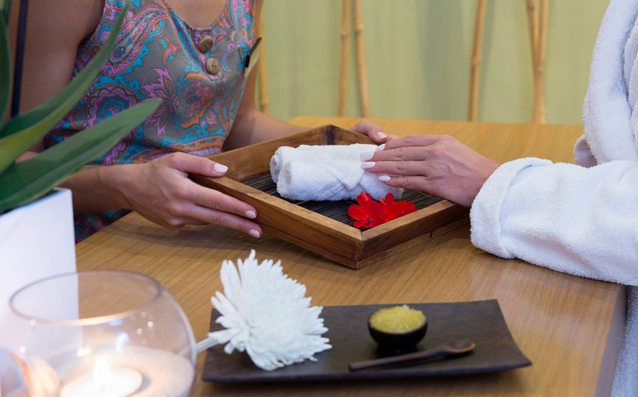 Recieving towel from spa desk employee